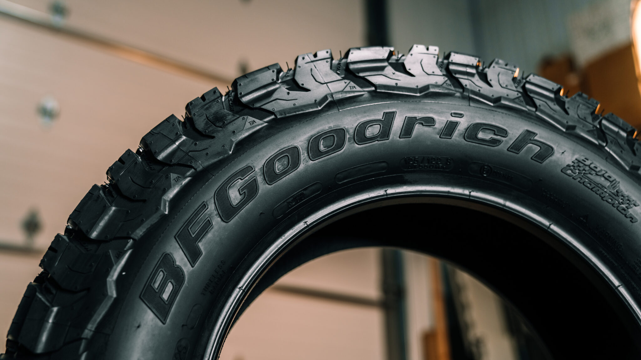 Close-up of BFGoodrich KO3 All-Terrain tire sidewall showcasing tread detail and branding.